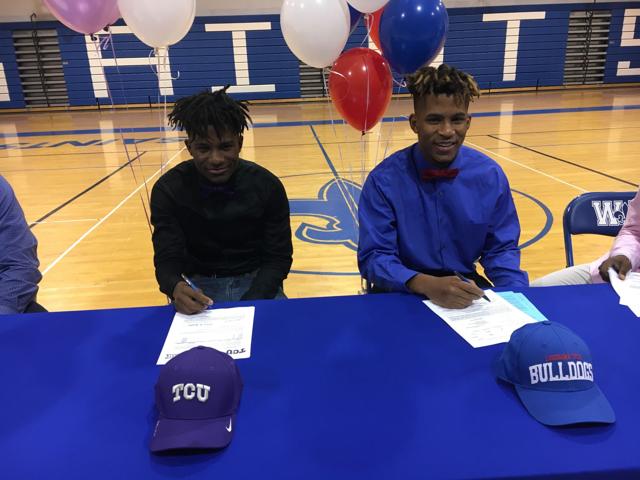 Image - Derius Davis (left) with his older brother, Derek Turner Jr., as they sign for their respective schools in 2018.