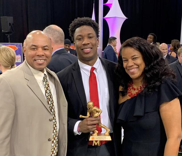 Image - KJ Henry in a family photo with his parents, Keith and Nicole Henry. 